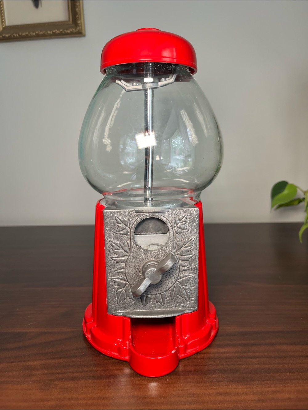 Vintage carousel gumball machine with a glass globe.